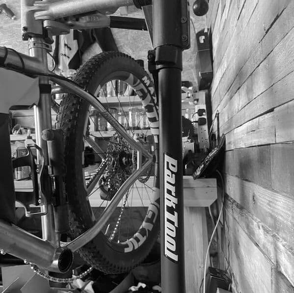 A titanium mountain bike in the work stand at the Travers Bikes workshop